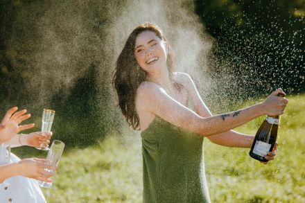 A Woman Sprinkling Champagne in the Air